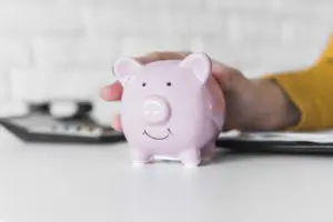 close up woman holding piggy bank